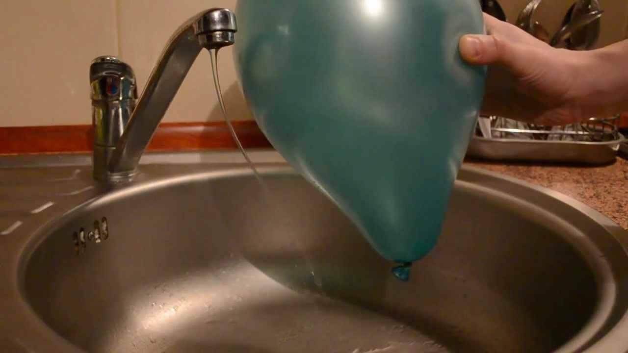 A charged balloon is attracted by a jet of water